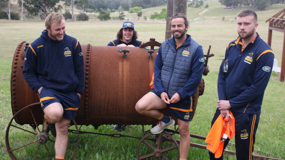 Berry's Will Miller with Lachlan Lonergan, Andy Muirhead and Mack Hansen, who helped rebuild fences in fire-affected communities on Wednesday. Photo: Brumbies Media