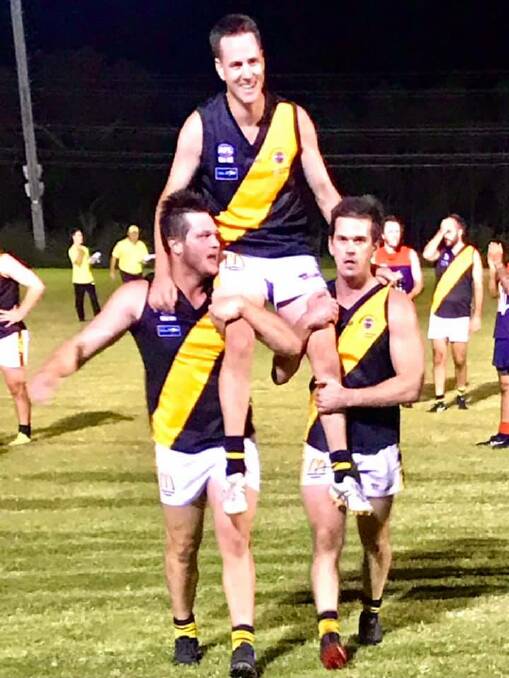 Luke McCann is carried off West Street Oval by teammates Max Hughes and Matt Polman on Friday night. Photo: Supplied