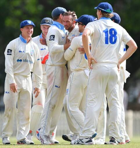 Matthew Gilkes (left) and his NSW Blues celebrate a wicket against South Australia. Photo: CRICKET NSW