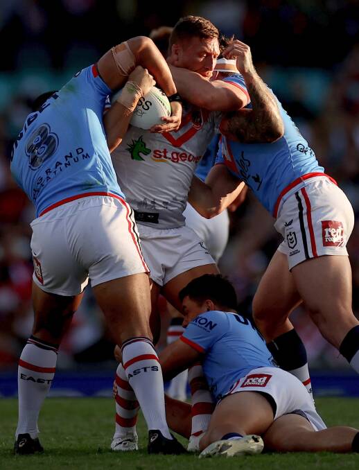 Gerringong's Tariq Sims wrestles three Roosters defenders on Sunday. Photo: Cameron Spencer