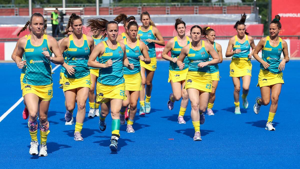 Grace Stewart (second from left), Kalindi Commerford (fourth from right) and their Hockeyroos warm-up ahead of a recent match. Photo: Hockey Australia