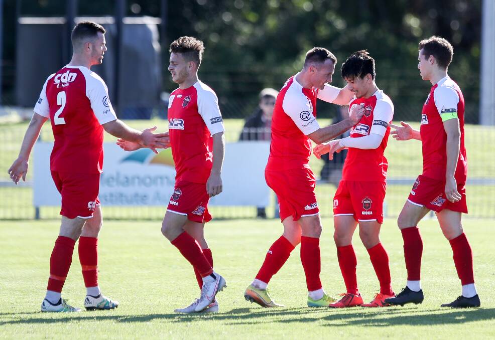 Chris Price (third from left) and his Wollongong Wolves lost 3-1 to Rockdale on Sunday. Photo: Adam McLean