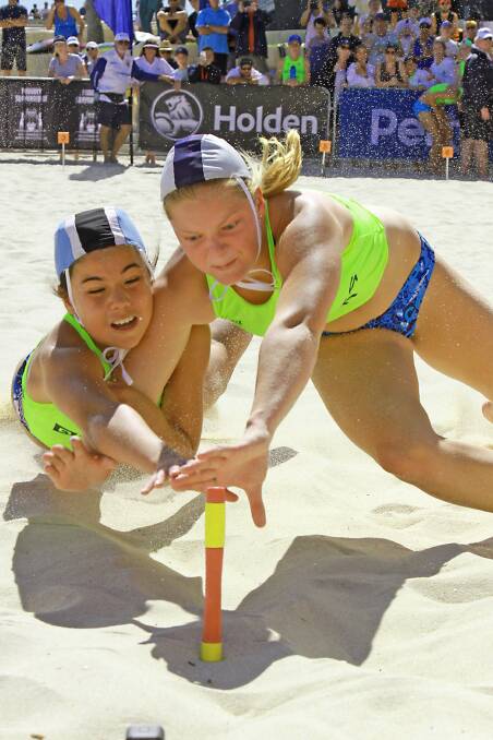 AT FULL STRETCH: Jacinta Davidson-Bunch and Holly Abbey battle in the final of the under 15s female beach flags at the Australian Championships. Photo: HARVPIX