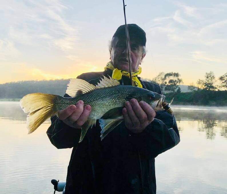 Mr Bass Man: John Daley with a Shoalhaven River fan tail bass. The best time to chase bass is early in the morning.