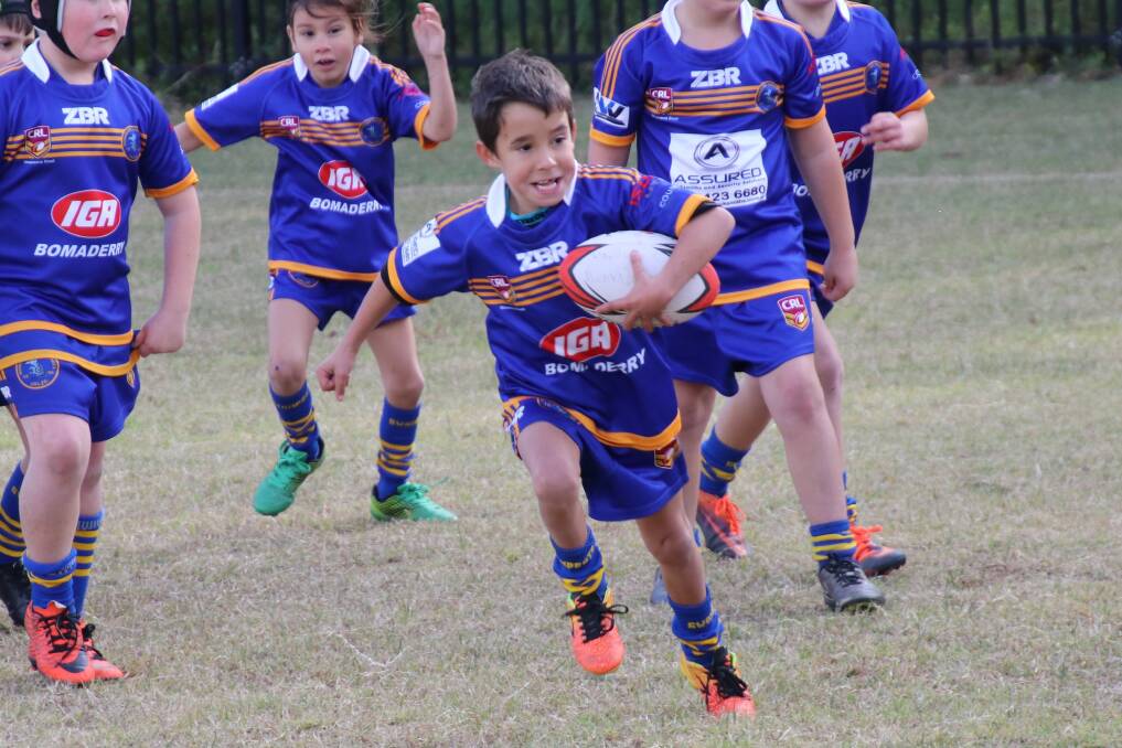 Go son!: Bomaderry Swamp Rats under 8s player Elijah Perry scored a great try last weekend in the match against St Georges Basin.