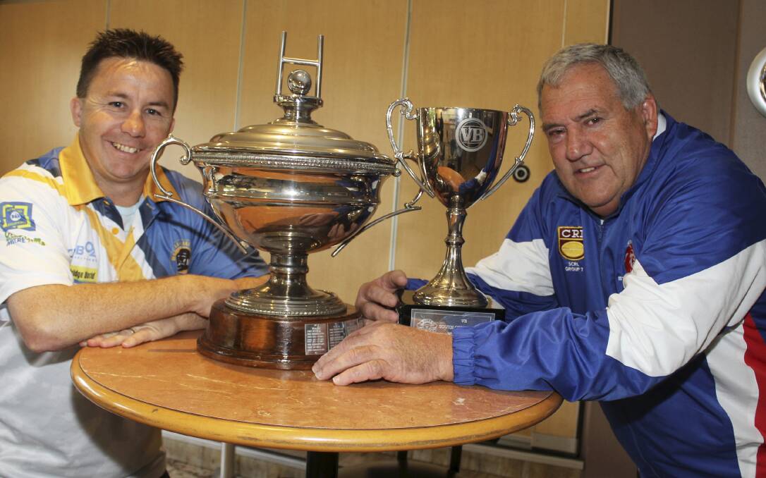 Peter Hooper (Warilla-Lake South) and Michael Cronin (Gerringong) get close up and personal with the first grade premiership trophies in 2013. Photo: David Hall