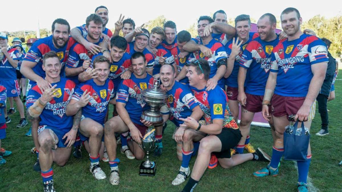 Jack Murchie (back row, seventh from left) and Reuben Garrick (back row, third from right) celebrate their 2015 Group Seven premiership their Gerringong Lions team. Photo: DAVID HALL