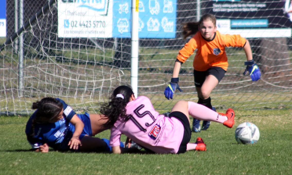 Under 15s goalkeeper Charlie Butler, in her first game for the club, makes a save for Southern Branch against St George. Photo: Freddie Simon