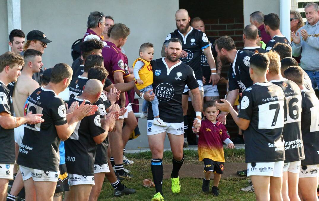 Sharks skipper Matt Carroll walks onto the field for his 100th Shellharbour first grade game with his two sons Mase (left) and Knox (right). Photo: Game Face Photography