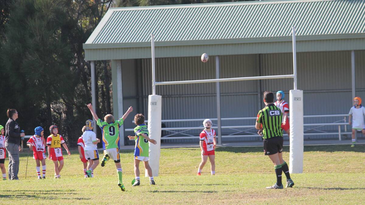 Through the middle: Culburra Dolphins U8 player Fergus Coughlan kicks a goal. The U8s had a convincing 32-8 win over St George’s Basin. Photo: Paul Coughlan