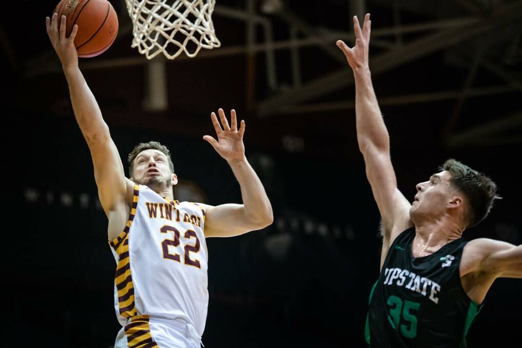 Kyle Zunic goes for a lay-up for Winthrop. Photo: EAGLES MEDIA