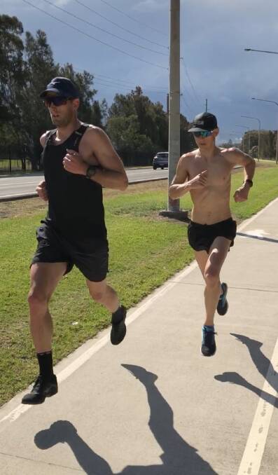 Sam Douglas and Jonathon Goerlach push each other during training.
