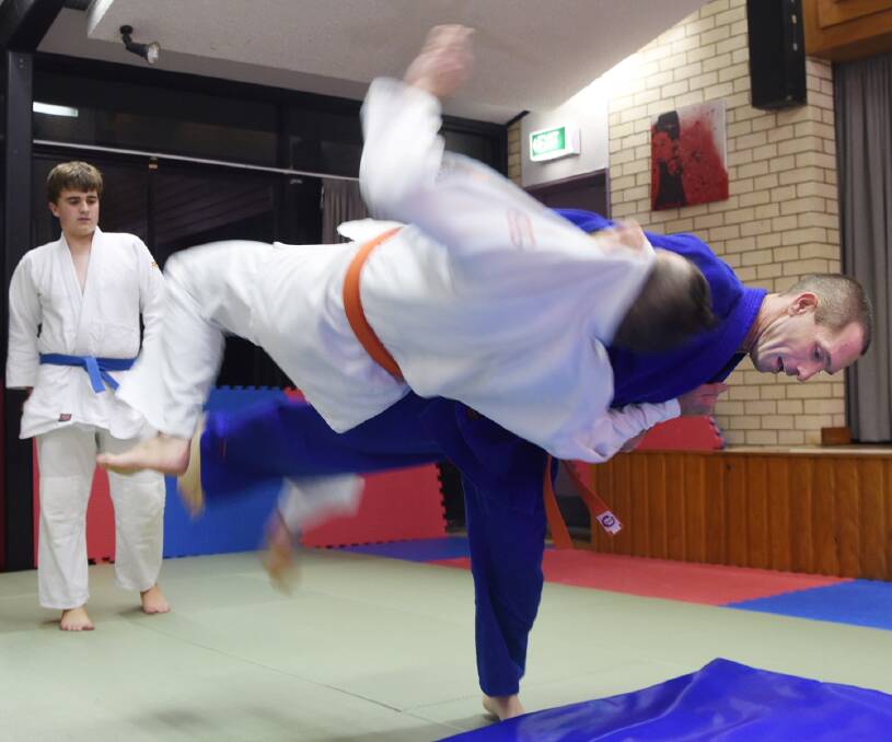Training hard: Michael Hall throwing Adrian Turley as they practise for their next belt grading.