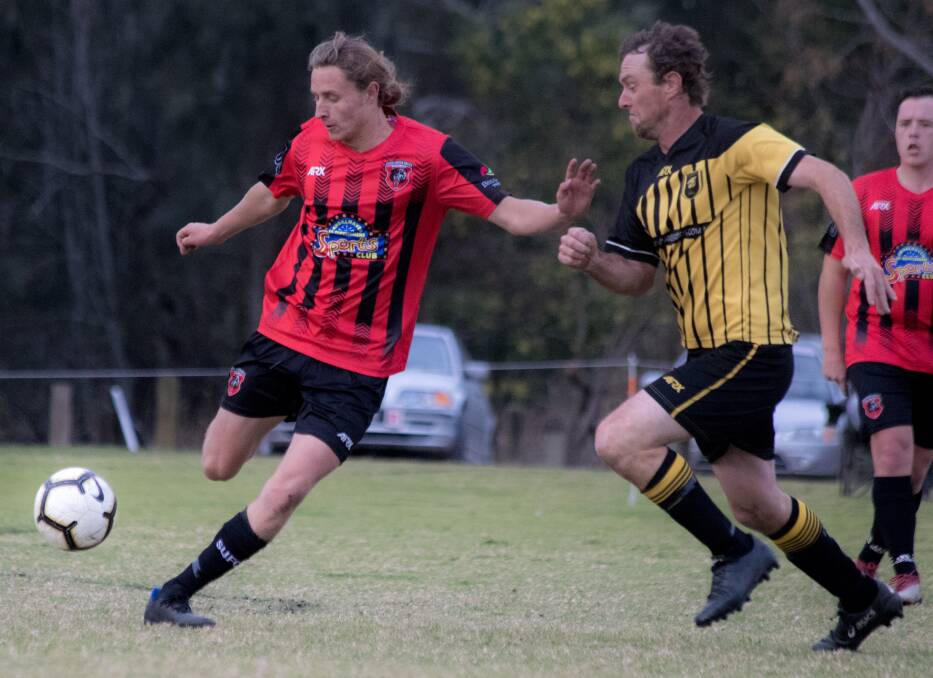 Shoalhaven United's Tim Bagnall and Bomaderry's Daniel Frew contest the ball during a SDFA match in 2019. Photo: TEAM SHOT STUDIOS