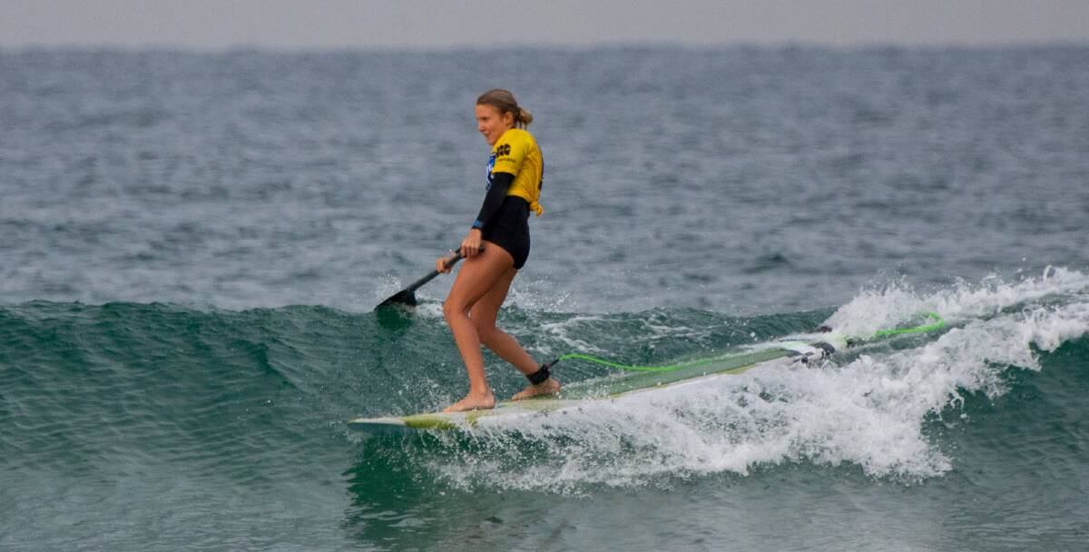 Berrara's Skyla Rayner on her way to winning the open women's 10-foot SUP division. Photo: Josh Brown/Surfing NSW