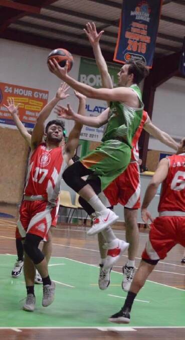 Moss Vale's Kyle Leslie goes for a lay-up against St George. Photo: Roz Wellington