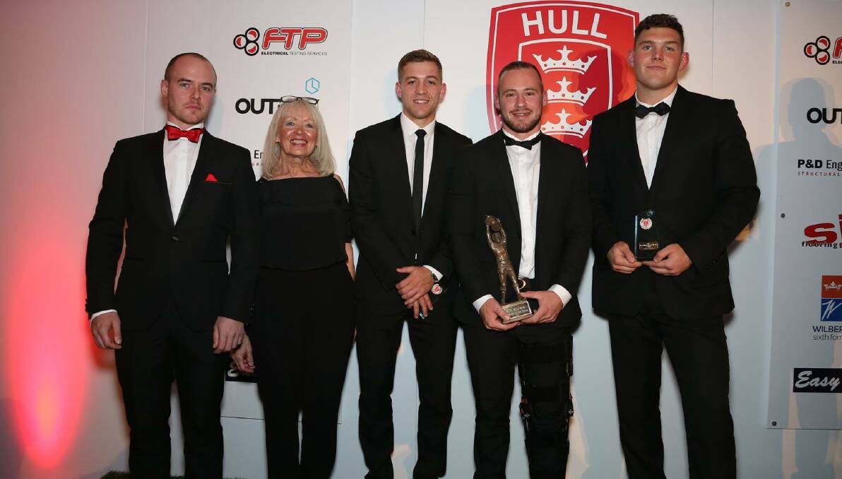 Adam Quinlan (second from right) with one of his awards on the night. Photo: ROVERS MEDIA