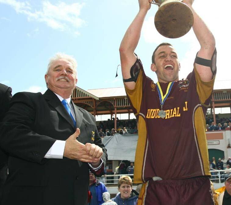 John Costello, as Group Seven director, presents Shellharbour Sharks' Matt Cody the reserve grade trophy at the Nowra Showground in 2006. Photo: David Hall 