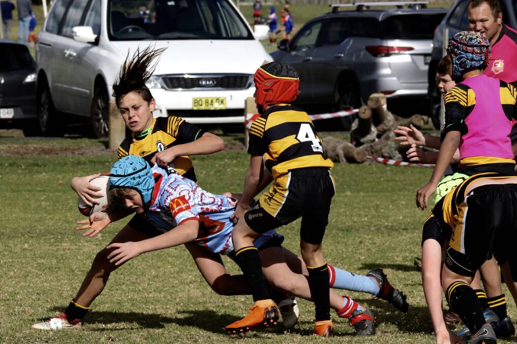 Desperate defence: Under 11 warrior Chase Mumberson successfully defends his line against the Milton Ulladulla Bulldog attacker.