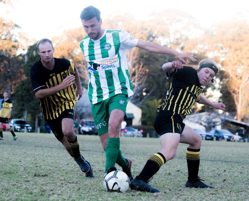 Huskisson-Vincentia's Sam Duffy splits two Bomaderry defenders during a recent match. Photo: TEAM SHOT STUDIOS