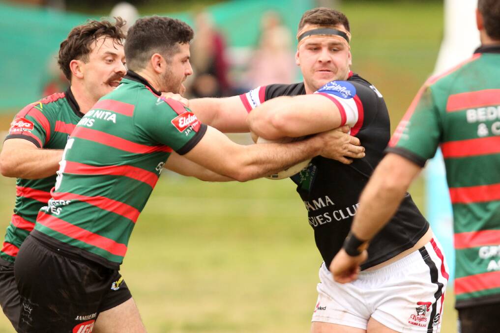 Kiama Knights' Tom Angel tries to avoid being tackled by Jamberoo Superoos' Mark Asquith. Photo: David Hall