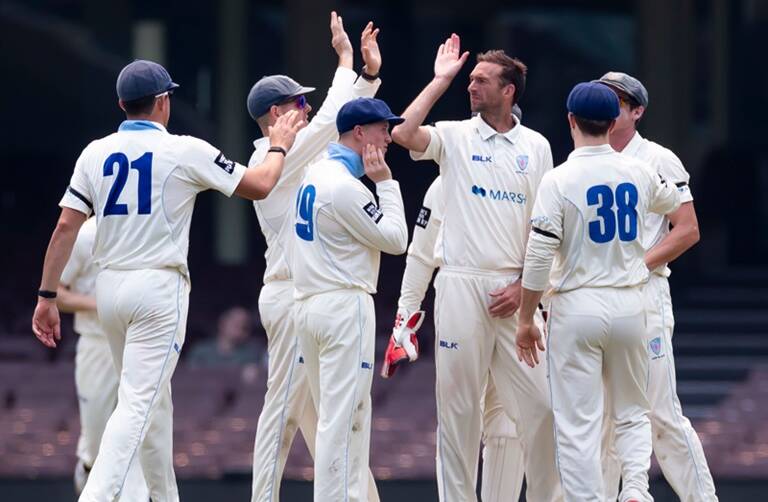 Matthew Gilkes (third from left) and his NSW Blues celebrate a wicket during a previous Sheffield Shield clash. Photo: CRICKET NSW