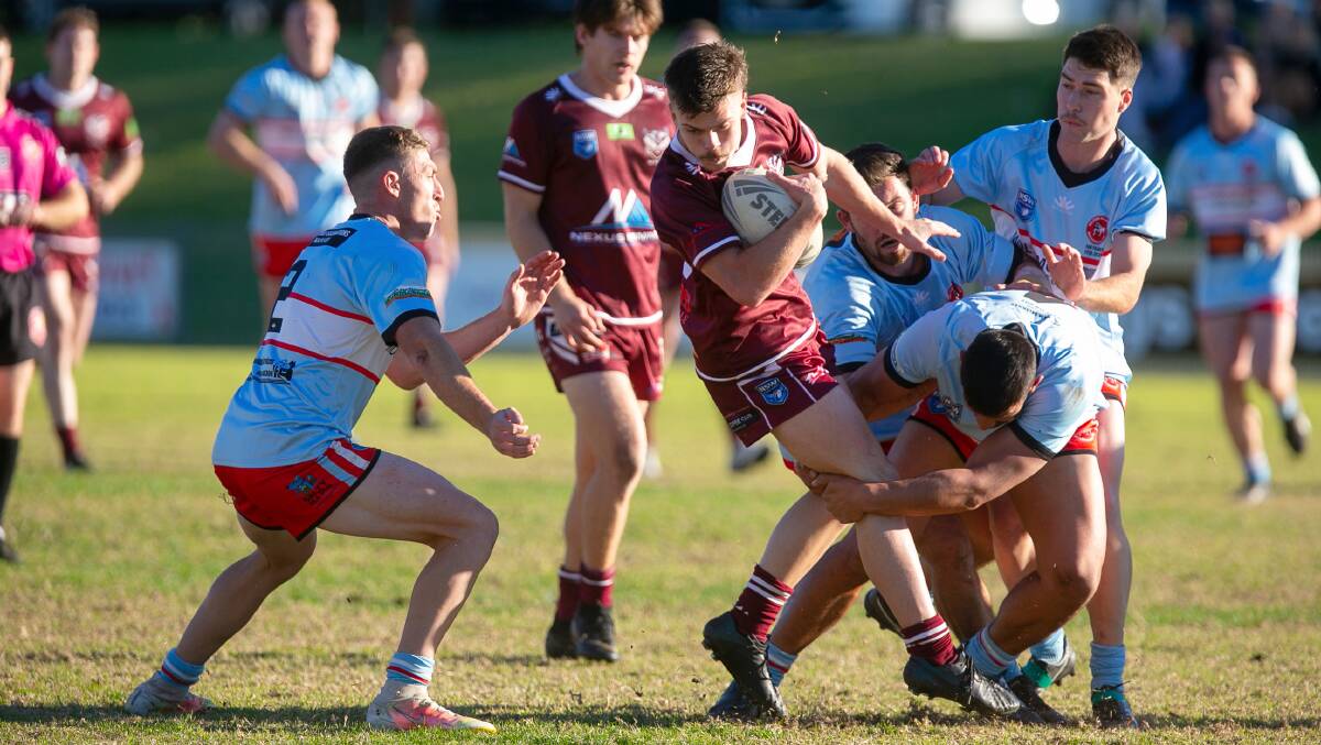 Albion Park-Oak Flats' Jesse Prinsse is tackled by numerous Milton-Ulladulla defenders during the 2021 season. Photo: Anna Warr