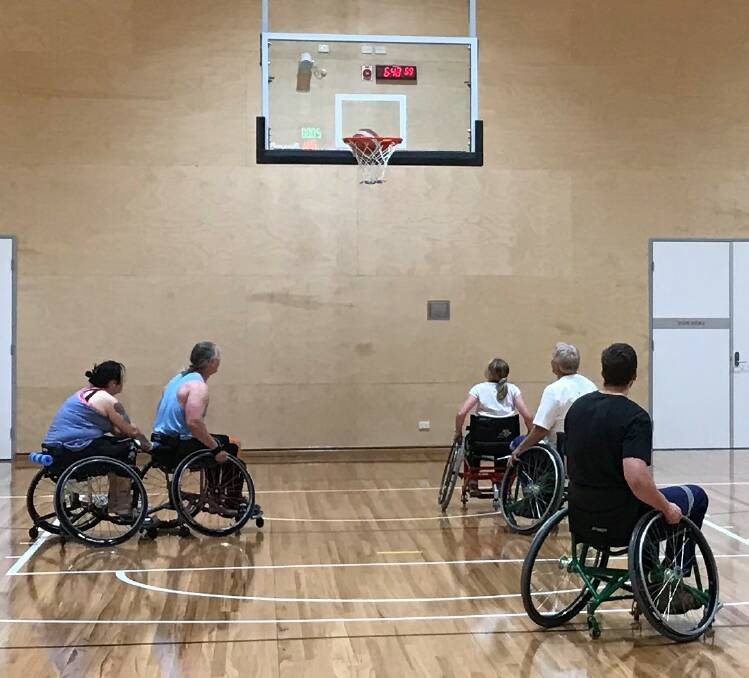 Players take part in wheelchair basketball at the Shoalhaven Indoor Sports Centre.