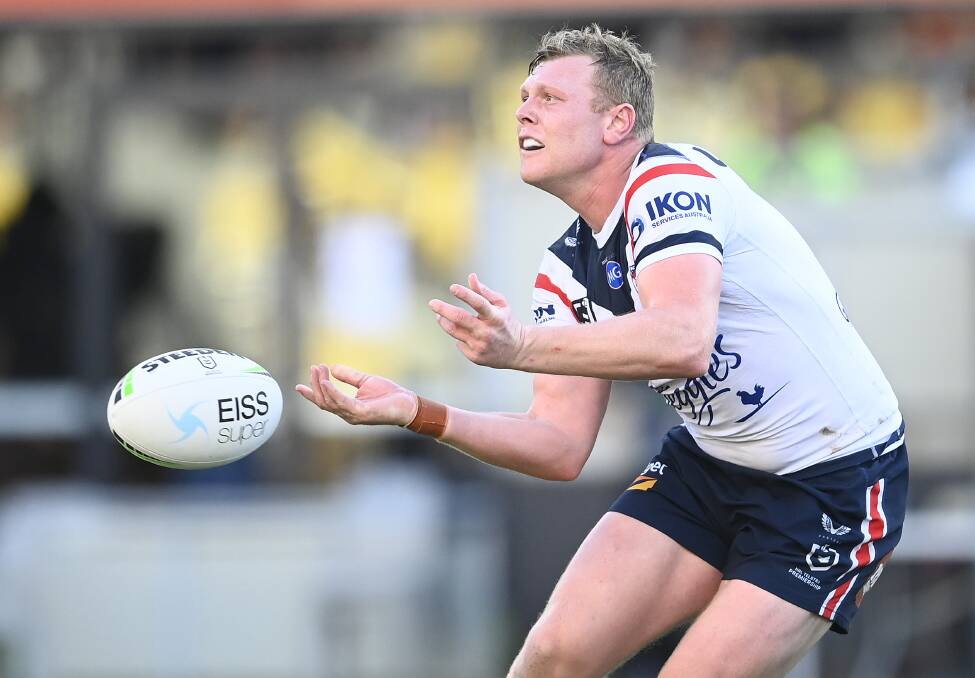 Drew Hutchison passes to a Roosters teammate on Saturday against the Cowboys. Photo: Ian Hitchcock