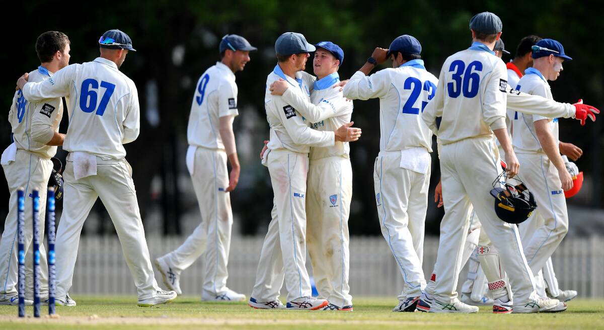 Matthew Gilkes (fifth from left) and his NSW Blues celebrate a wicket during the 2019/20 Sheffield Shield season. Photo: CRICKET NSW