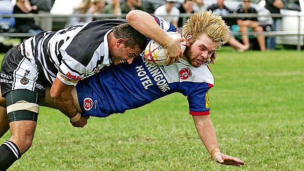 Gerringong's Tim Moore is tackled during the 2011 Group Seven Rugby League season. Photo: Richard Whitby.