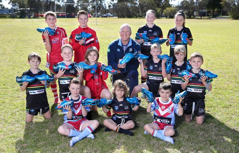 Paul Sironen presents players from St Georges Basin, Milton-Ulladulla and Sussex Inlet junior rugby league clubs with their new boots. Photo: NSWRL
