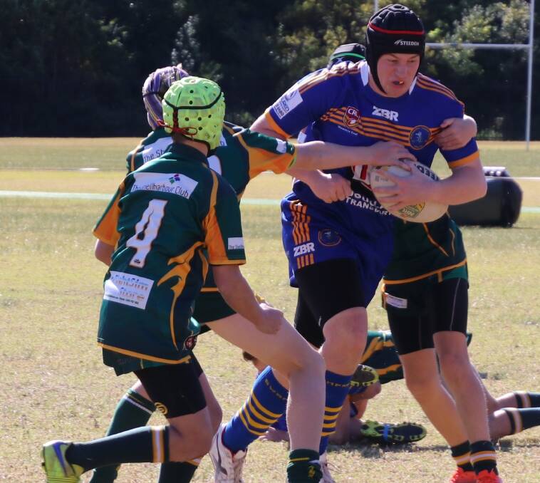 Up the middle: Bomaderry's under 14 player Jaiden Moore busts the defence. Jaiden scored a hat-trick of tries last Saturday in his side's great win over the Stingrays. The final score was 48-10.