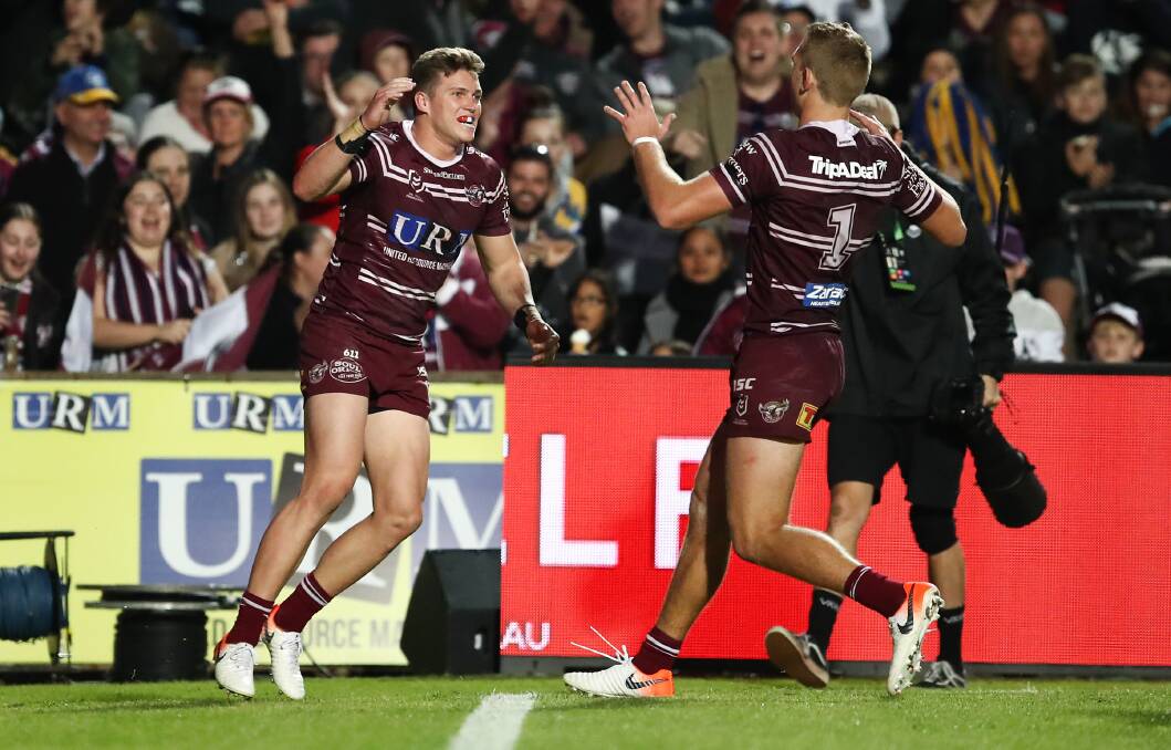 Reuben Garrick celebrates a try with Manly-Warringah team mate Tom Trbojevic. Photo: Brendon Thorne