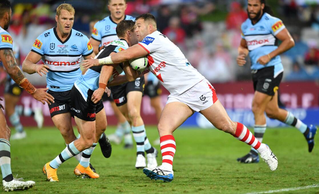 Trent Merrin takes a hit-up for the Dragons against the Sharks. Photo: NRL Imagery