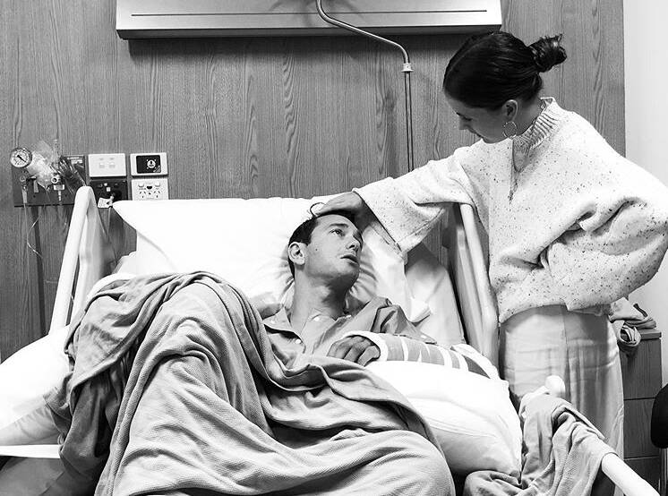 Ali Day in the hospital with his partner Kel King. Photo: SUPPLIED