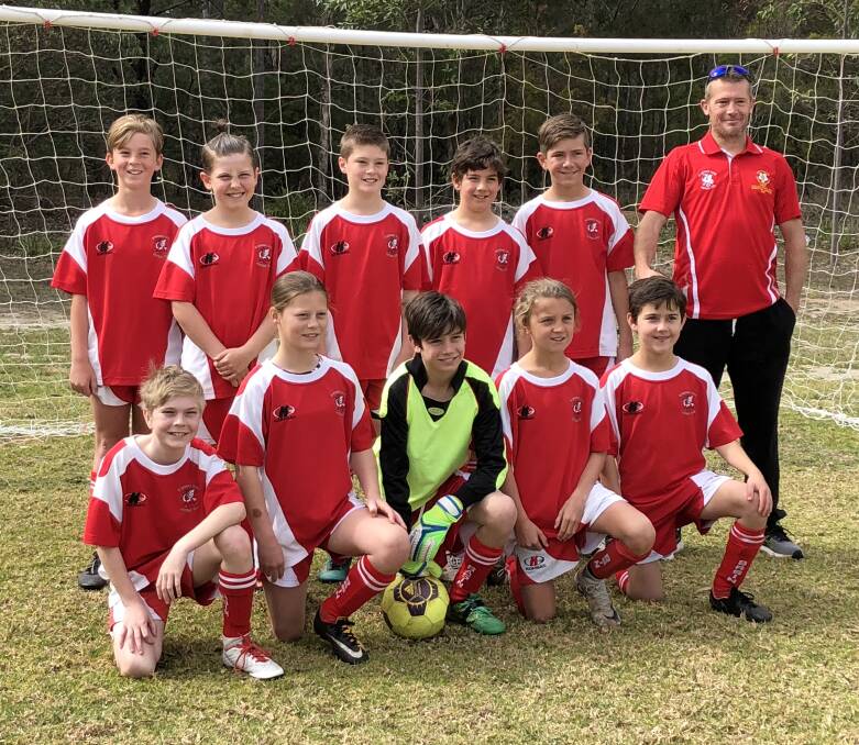 Fantastic year: Coach Brian Booth with the Basin Under 11s Red team who gave a great account of themselves in the grand final against Huskisson.