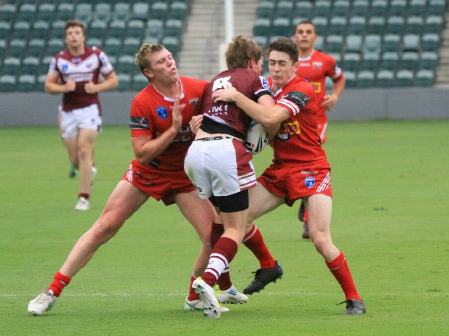 Illawarra's Drew Hutchison and Adam Clune make a tackle against Manly-Warringah in the 2013 SG Ball competition. Photo: Allan Barry