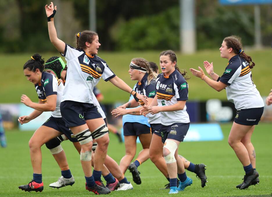 Harriet Elleman (right) and her ACT teammates celebrate a late penalty goal on Saturday. Photo: Brumbies Media