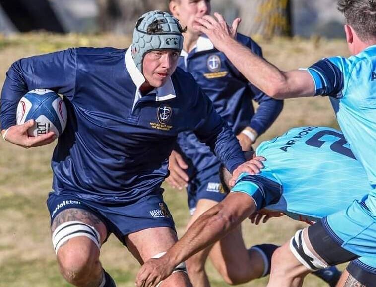 Shoalhaven's Rugby Club's Michael Dun makes a run for his navy side. Photo: Jayzie Photography