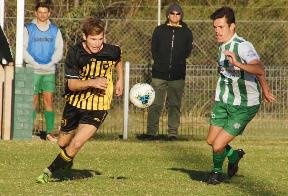 Bomaderry's Brendan Kellett and Huskisson-Vincentia's Lewis Archibald attack the ball at the weekend. Photo: RACH HALL