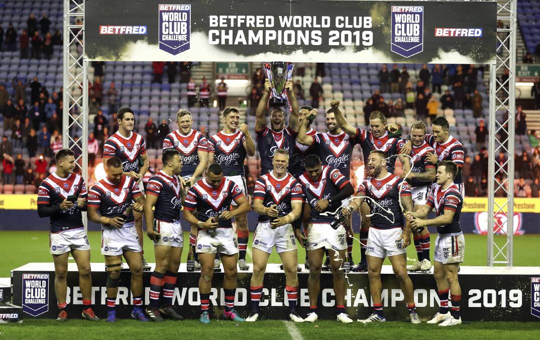 Brett Morris (back row, second from left) and the Sydney Roosters after their World Club Challenge win. Photo: Martin Rickett