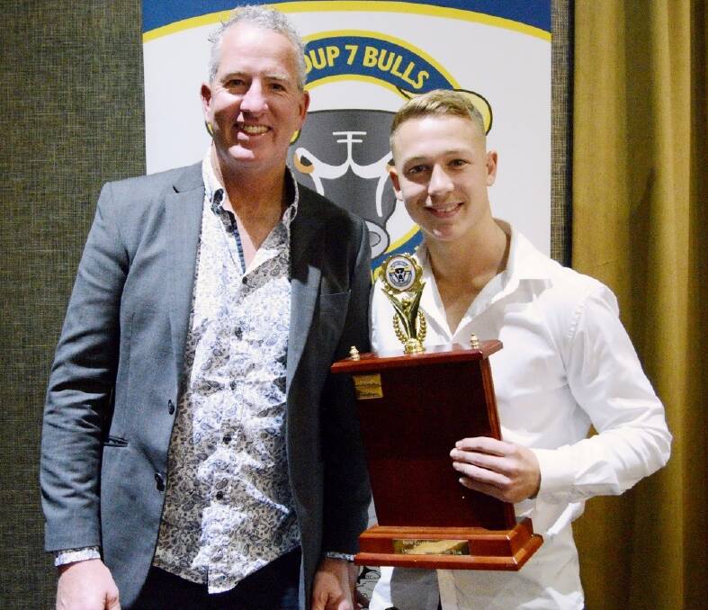 Scott McLaurin presents Sam Hooper with the Bill James Under 18s Player of the Year Trophy. Photo: GREG RUGBY SPORTS PHOTOS