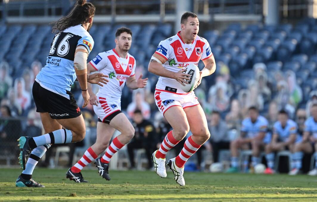 Shellharbour's Trent Merrin makes a run for St George Illawarra on Sunday, with Albion Park-Oak Flats' Adam Clune in support. Photo: Dragons Media