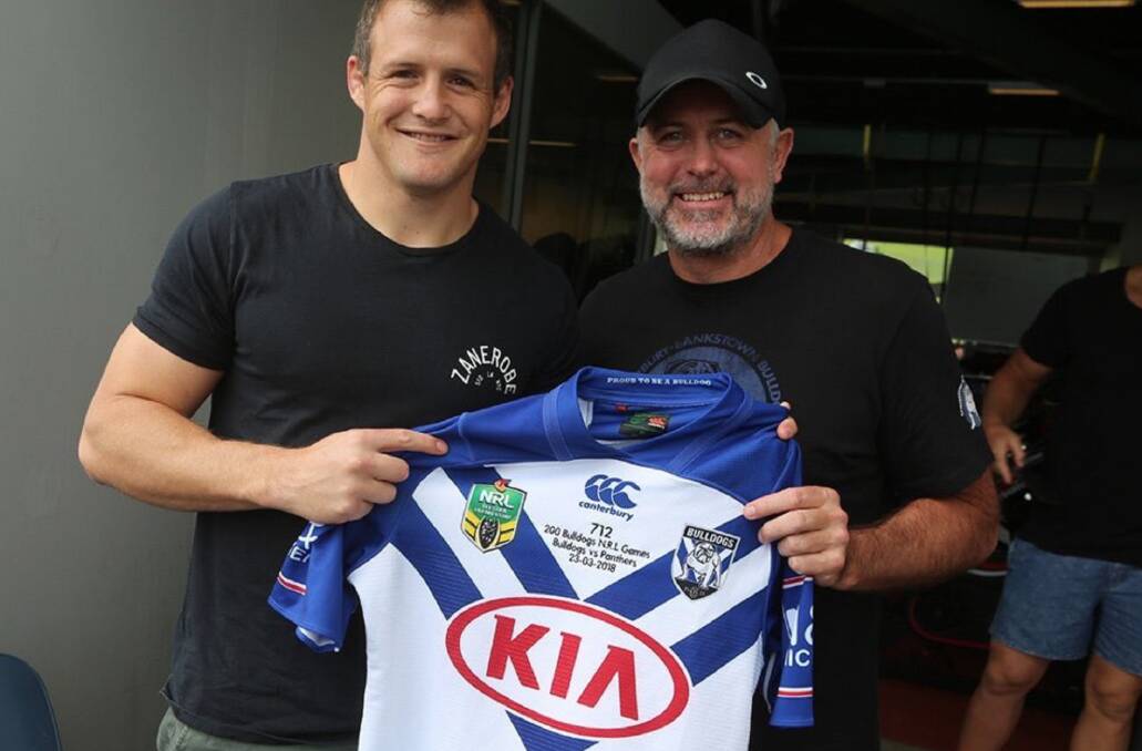 Josh Morris is presented his jersey by coach Dean Pay. Photo: BULLDOGS MEDIA