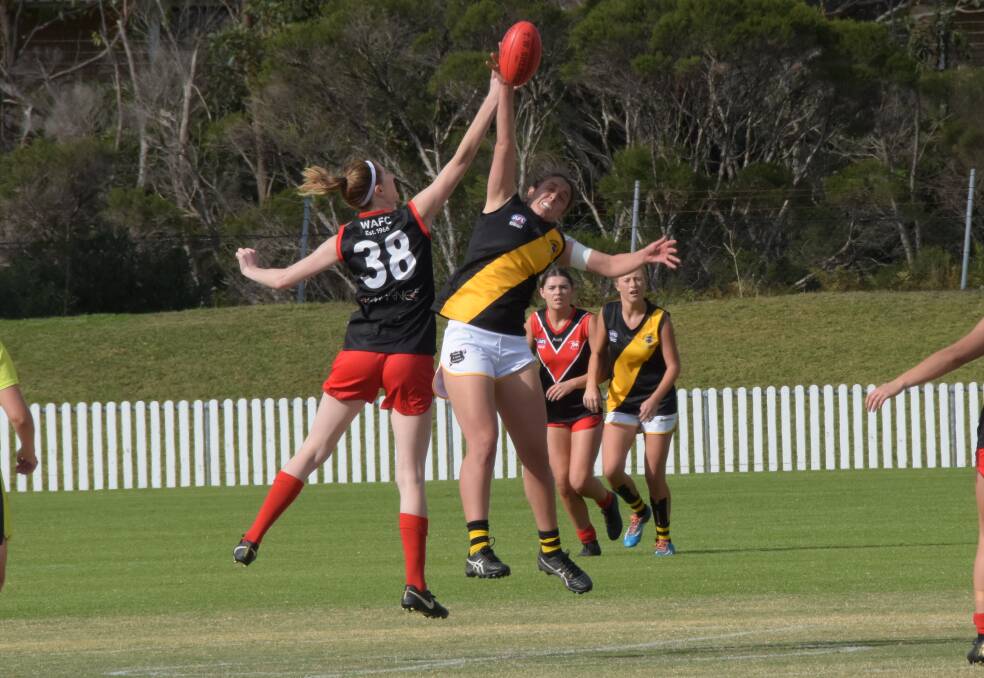 CONTEST: Bomaderry's Emma Dempsey wins a ruck tap for her team against the Wollongong Lions on Saturday at North Dalton Park. Photo: COURTNEY WARD