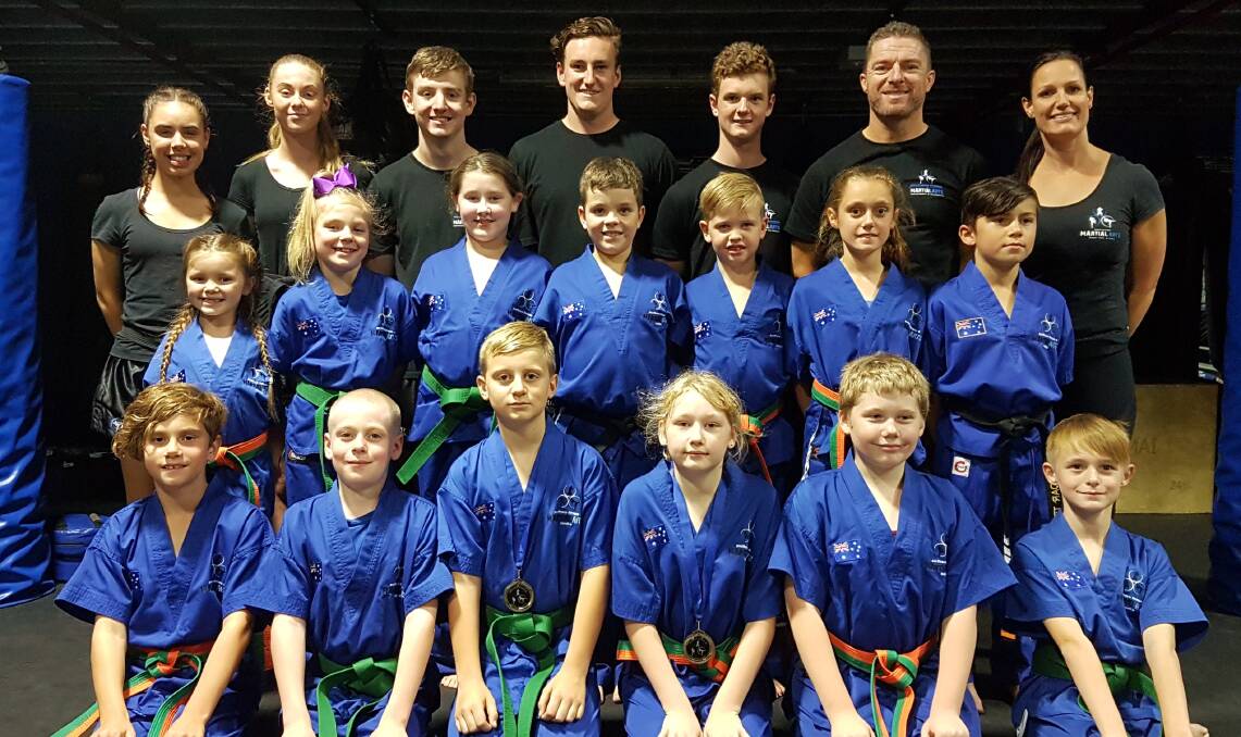 POTENTIAL: Southern Fitness and Martial Arts Centre Bomaderry's intermediate junior kick-defence pose with their instructors following their gradings.