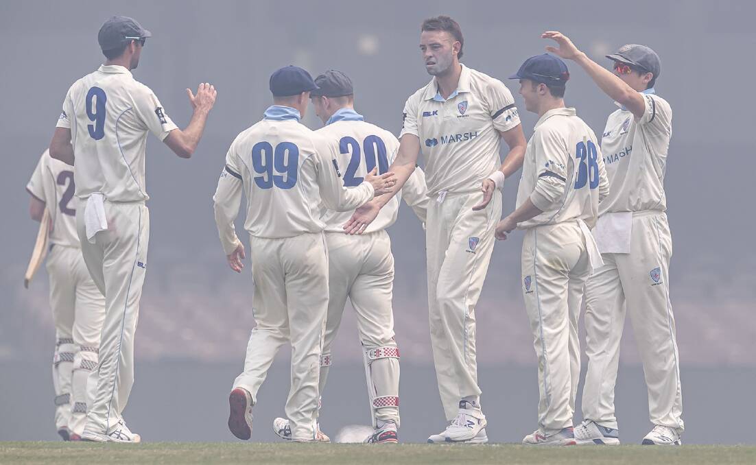 Matthew Gilkes (90) and his NSW Blues teammates celebrate a wicket during the match with Queensland. Photo: CRICKET NSW
