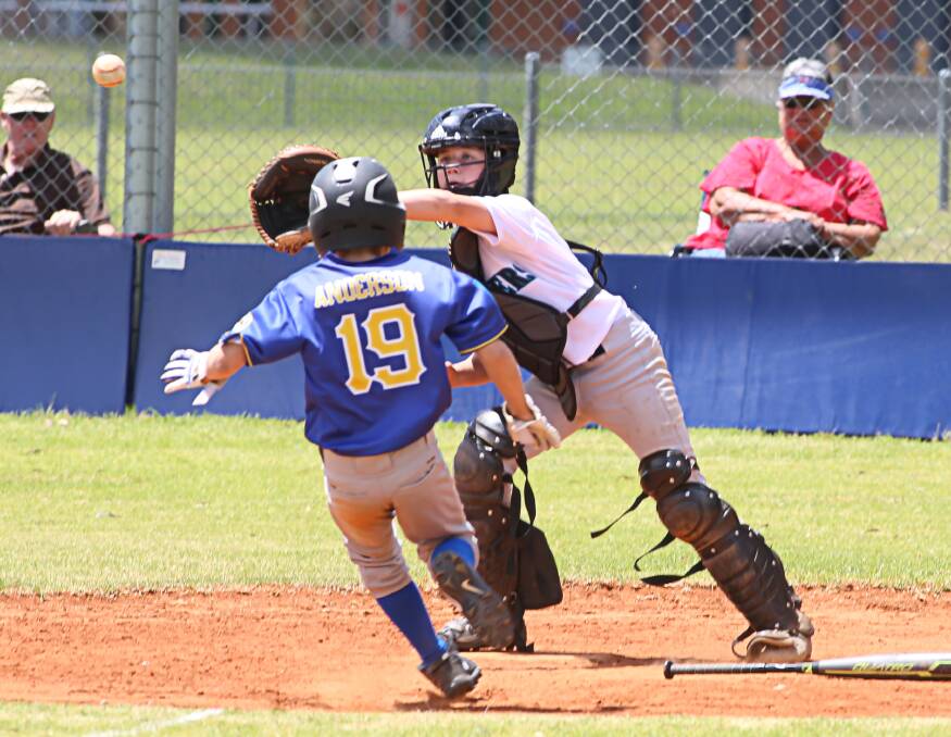The heat's on: Shoalhaven Mariners catcher Mackenzie Mannix makes the out in the game against Eagles. Mariners had a 15-7 victory, their second win over the Berkeley side this season. 