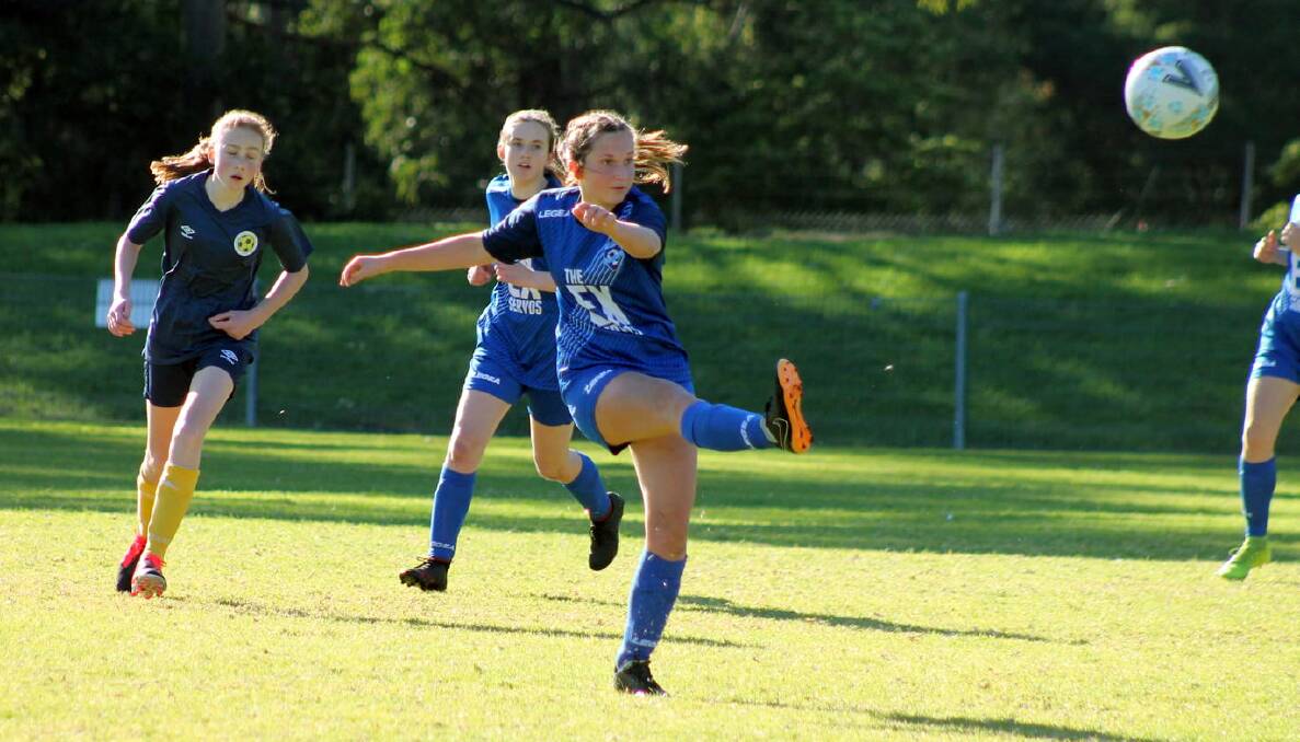 Southern Branch's Kaitlin Garin clears the ball against Western NSW in the under 14s clash. Photo: Bob Willetts
